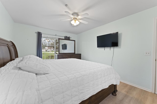 bedroom with baseboards, ceiling fan, and wood finished floors