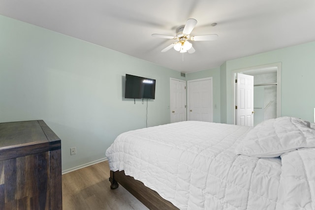 bedroom with baseboards, ceiling fan, and wood finished floors