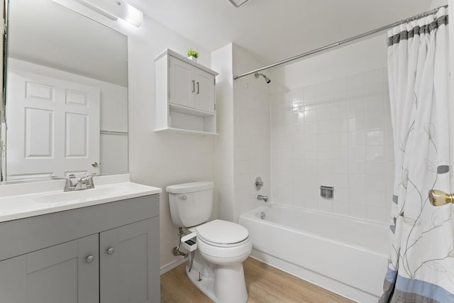 full bathroom with vanity, toilet, wood finished floors, and shower / tub combo