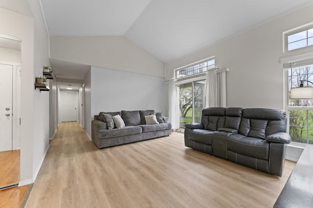 living area with light wood-type flooring and high vaulted ceiling