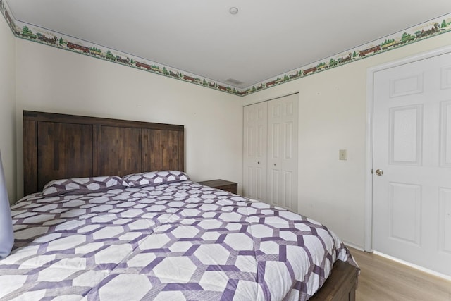 bedroom featuring a closet and wood finished floors