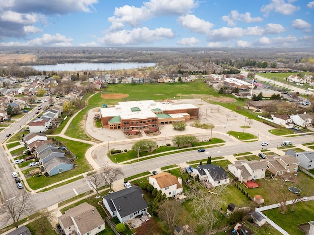 drone / aerial view with a water view and a residential view