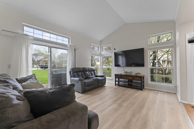 living room with light wood-style floors, high vaulted ceiling, and visible vents
