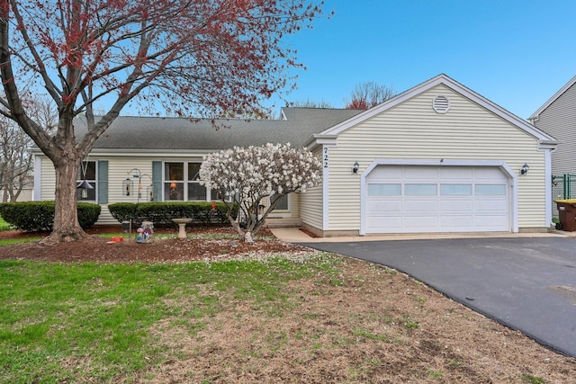 ranch-style house with driveway and a garage