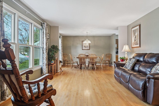 living room featuring an inviting chandelier and light wood-type flooring