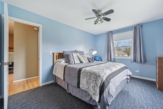 carpeted bedroom featuring ceiling fan and baseboards
