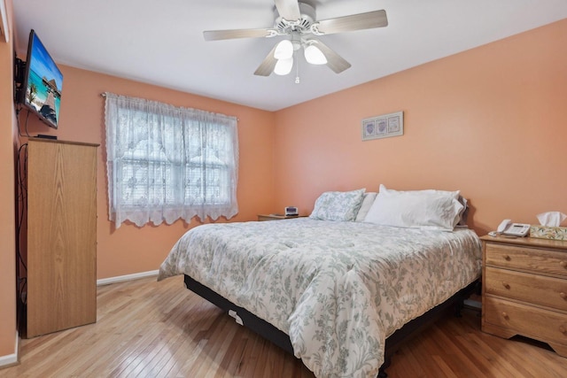bedroom with wood finished floors, baseboards, and ceiling fan