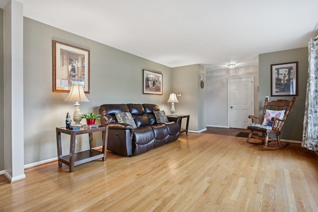 living room with baseboards and light wood-type flooring