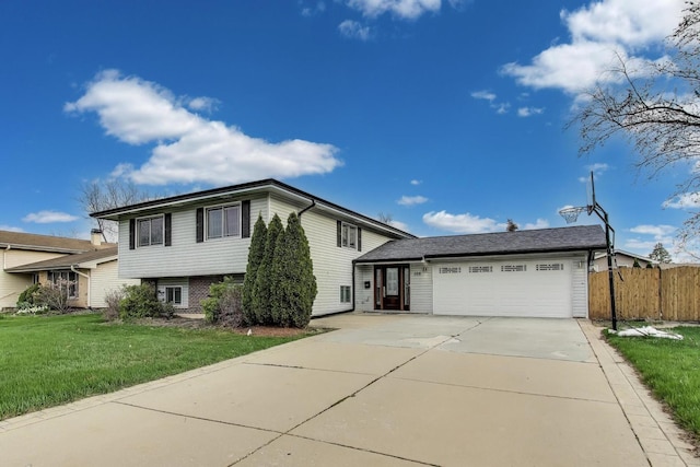 tri-level home with concrete driveway and an attached garage