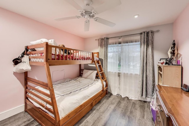 bedroom with wood finished floors, ceiling fan, baseboards, and recessed lighting