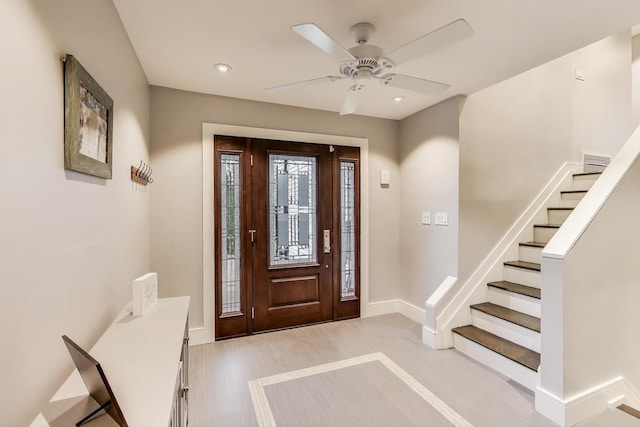 foyer entrance featuring baseboards, ceiling fan, stairs, and recessed lighting