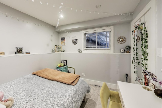bedroom featuring carpet flooring and vaulted ceiling