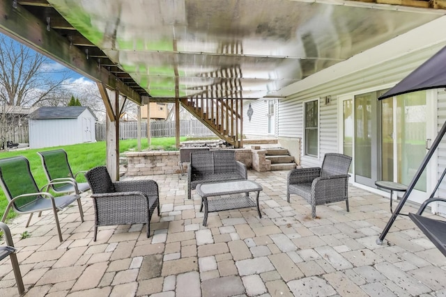 view of patio / terrace featuring stairs, a shed, and an outdoor structure