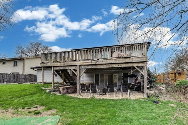 rear view of house with a deck, a patio area, and stairs