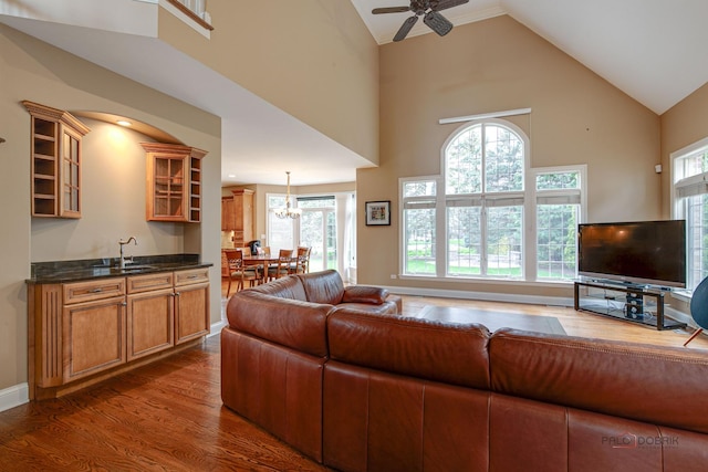living room with a ceiling fan, high vaulted ceiling, and dark wood finished floors