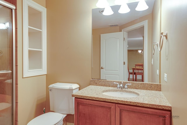 bathroom featuring vanity, a stall shower, visible vents, and toilet