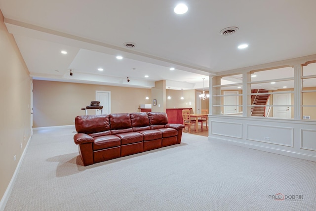 carpeted living room featuring visible vents, recessed lighting, baseboards, and an inviting chandelier