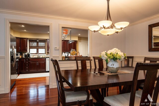11012 S Theresa Cir Unit 3C, Palos Hills, IL 60465 - dining room featuring wood finished floors, a decorative wall, crown molding, and a notable chandelier