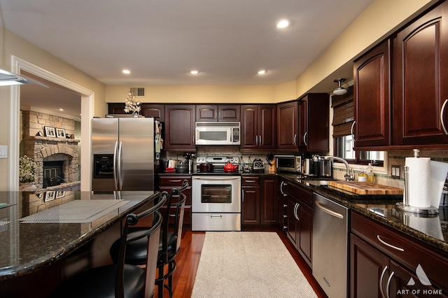 11012 S Theresa Cir Unit 3C, Palos Hills, IL 60465 - kitchen featuring dark stone counters, appliances with stainless steel finishes, a sink, and visible vents