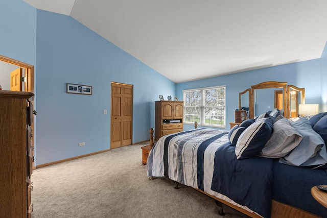 bedroom with light colored carpet, baseboards, and high vaulted ceiling