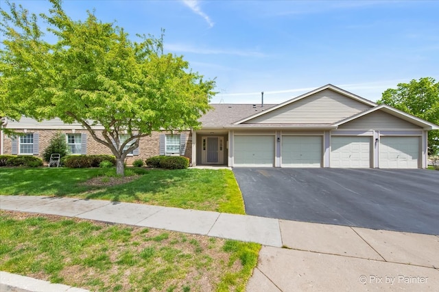 1023 Berkshire Ct Unit D, Elgin, IL 60120 - view of front facade featuring driveway, a front lawn, a garage, and brick siding
