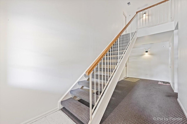 1023 Berkshire Ct Unit D, Elgin, IL 60120 - staircase with baseboards, a high ceiling, and carpet