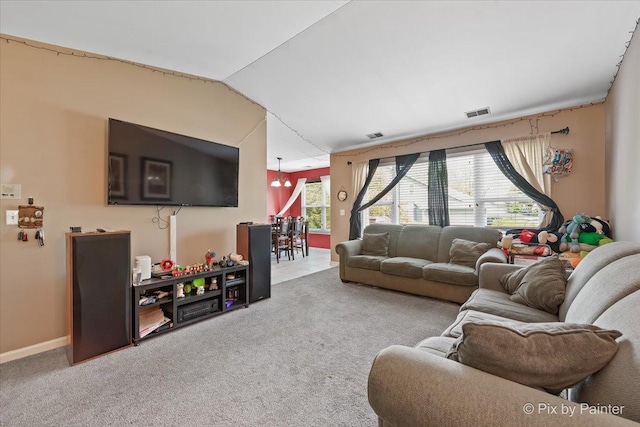 1023 Berkshire Ct Unit D, Elgin, IL 60120 - carpeted living area featuring vaulted ceiling and baseboards