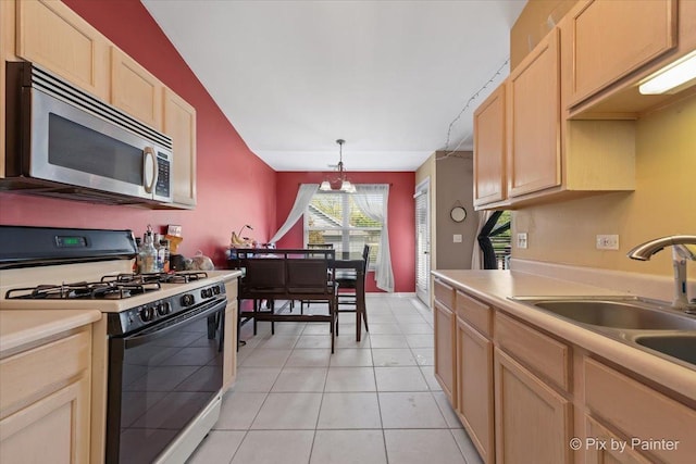 1023 Berkshire Ct Unit D, Elgin, IL 60120 - kitchen with range with gas stovetop, stainless steel microwave, light countertops, light tile patterned floors, and hanging light fixtures