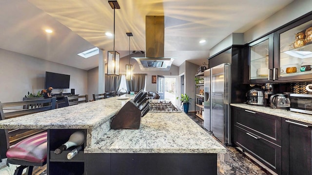 8129 45th Pl, Lyons, IL 60534 - kitchen featuring light stone counters, vaulted ceiling with skylight, island range hood, glass insert cabinets, and stainless steel appliances