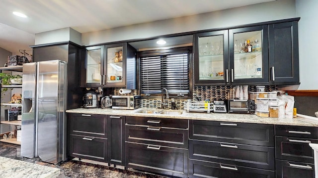 8129 45th Pl, Lyons, IL 60534 - bar featuring decorative backsplash, stainless steel refrigerator with ice dispenser, a toaster, and a sink