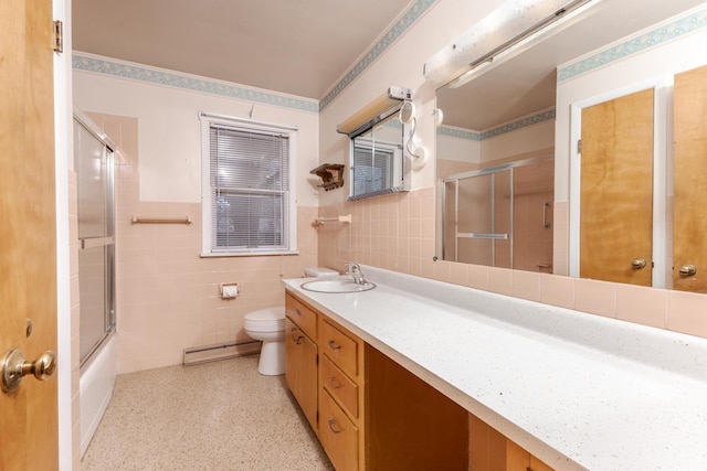 full bathroom featuring a baseboard heating unit, tile walls, vanity, toilet, and wainscoting