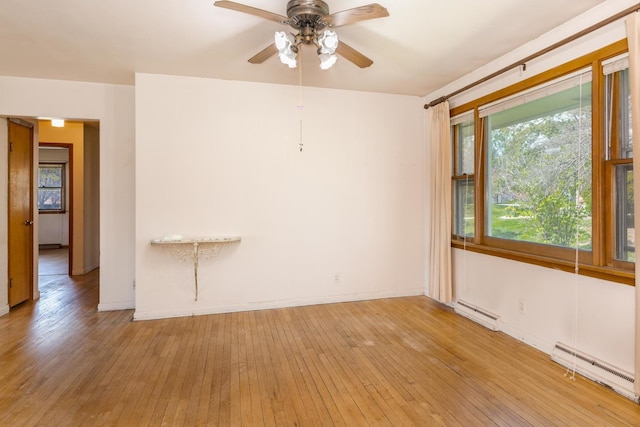 unfurnished room with ceiling fan, light wood-type flooring, and baseboard heating