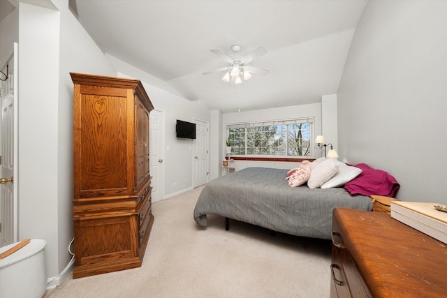 bedroom featuring baseboards, vaulted ceiling, a ceiling fan, and light colored carpet