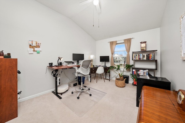 carpeted home office with vaulted ceiling, a ceiling fan, and baseboards