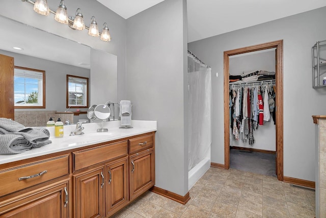 1035 Heritage Dr, Diamond, IL 60416 - full bathroom featuring visible vents, vanity, curtained shower, baseboards, and a walk in closet