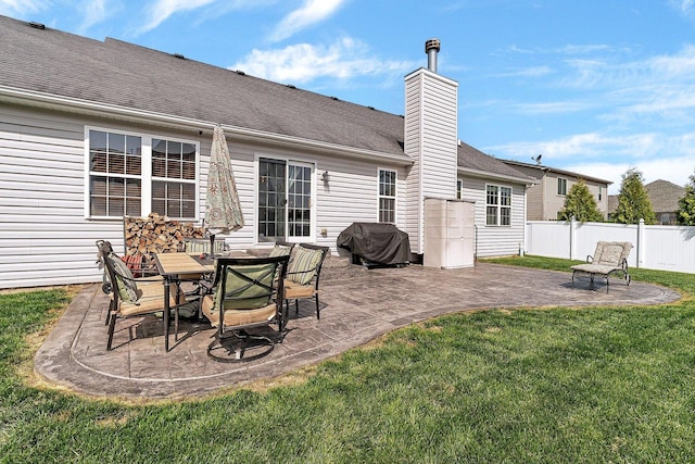 1035 Heritage Dr, Diamond, IL 60416 - rear view of house featuring a yard, fence, a chimney, and a patio area