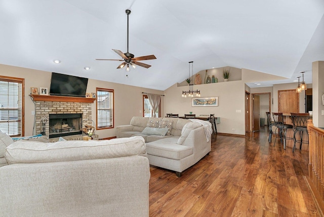 1035 Heritage Dr, Diamond, IL 60416 - living area featuring ceiling fan with notable chandelier, a fireplace, vaulted ceiling, and wood finished floors