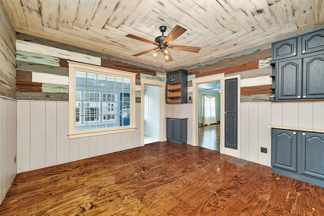 112 W 1st St, Streator, IL 61364 - unfurnished living room with wood walls, ceiling fan, and wood ceiling