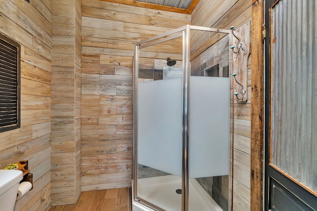 112 W 1st St, Streator, IL 61364 - bathroom featuring toilet, a shower stall, wood walls, and wood finished floors