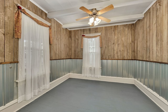 112 W 1st St, Streator, IL 61364 - spare room featuring wooden walls, a ceiling fan, and beam ceiling