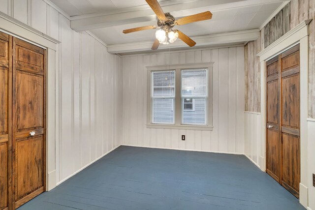 112 W 1st St, Streator, IL 61364 - spare room with beam ceiling, dark colored carpet, and ceiling fan