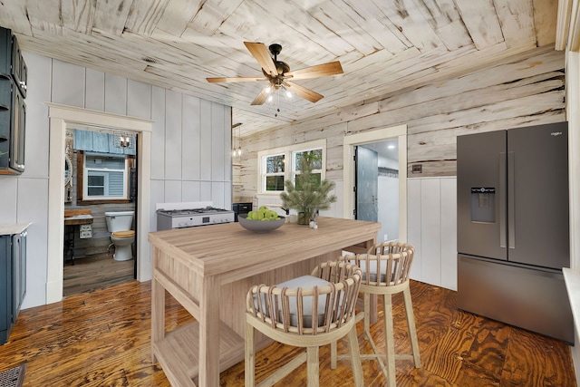 112 W 1st St, Streator, IL 61364 - dining area featuring wooden walls, a ceiling fan, wooden ceiling, and dark wood finished floors