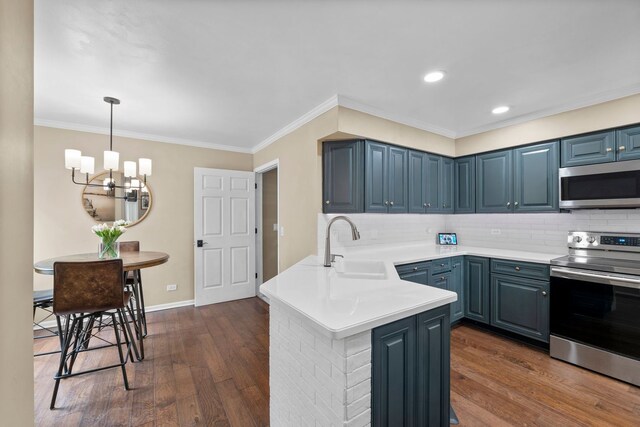 113 Welwyn St Unit 0, Lake Bluff, IL 60044 - kitchen featuring appliances with stainless steel finishes, a sink, a peninsula, dark wood-type flooring, and ornamental molding