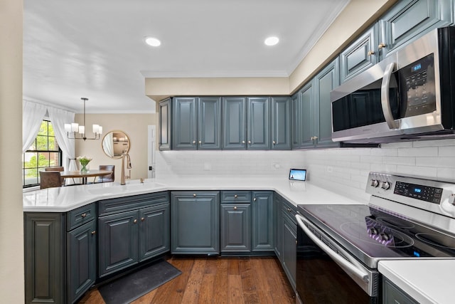 113 Welwyn St Unit 0, Lake Bluff, IL 60044 - kitchen featuring appliances with stainless steel finishes, a sink, a peninsula, a chandelier, and dark wood-style flooring