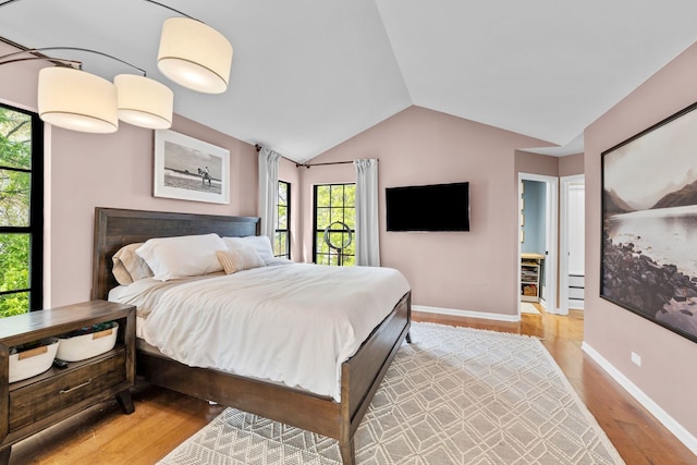 113 Welwyn St Unit 0, Lake Bluff, IL 60044 - bedroom with multiple windows, lofted ceiling, wood finished floors, and baseboards