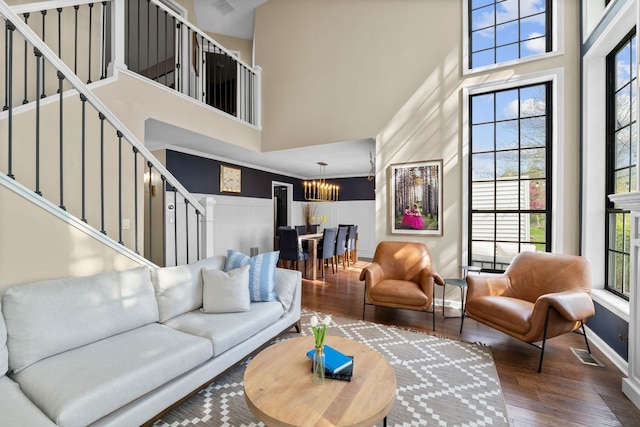 113 Welwyn St Unit 0, Lake Bluff, IL 60044 - living area featuring a high ceiling, a chandelier, stairs, wood finished floors, and baseboards