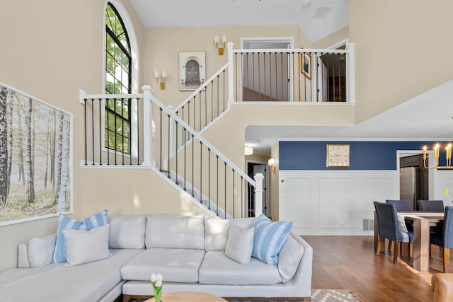 113 Welwyn St Unit 0, Lake Bluff, IL 60044 - living area with a chandelier, wood finished floors, a high ceiling, stairway, and wainscoting