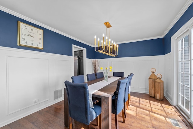 113 Welwyn St Unit 0, Lake Bluff, IL 60044 - dining space featuring a chandelier, a decorative wall, ornamental molding, and wood finished floors