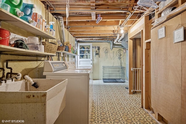laundry area featuring a sink, light floors, laundry area, and washer and clothes dryer