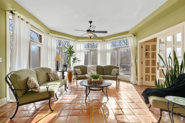sunroom with tile patterned flooring, french doors, and plenty of natural light
